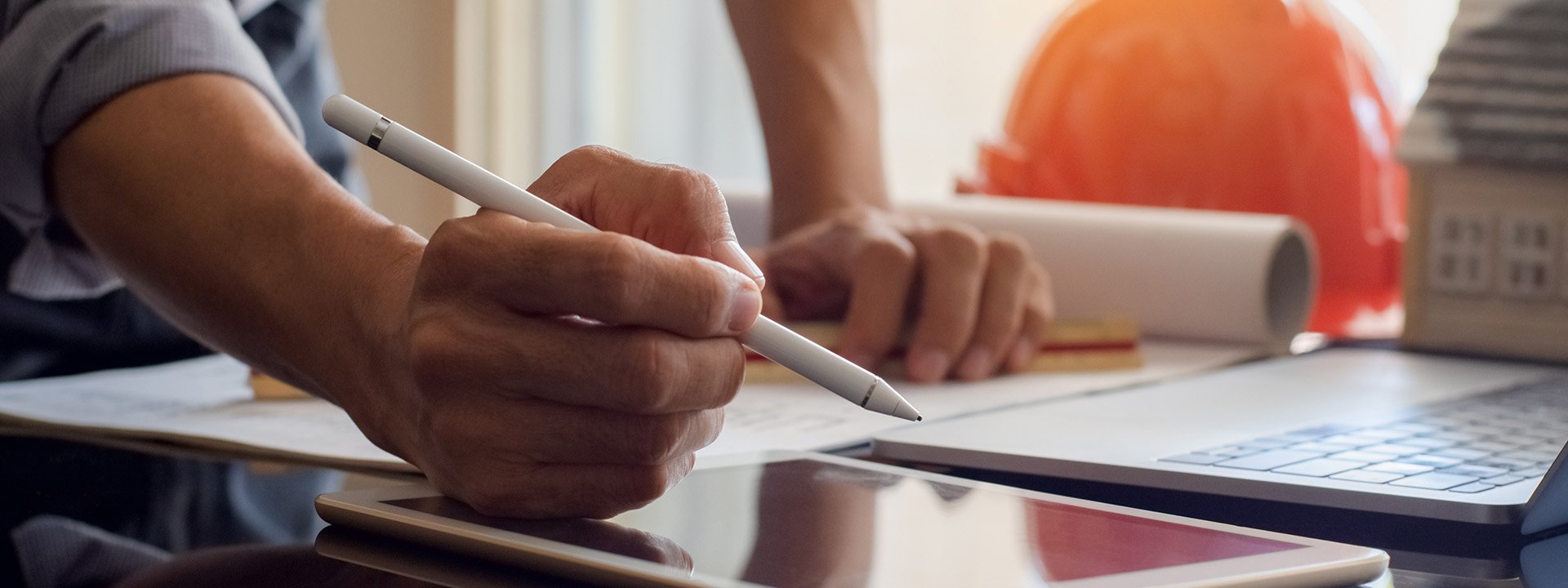 Closeup of person holding pen working on tablet