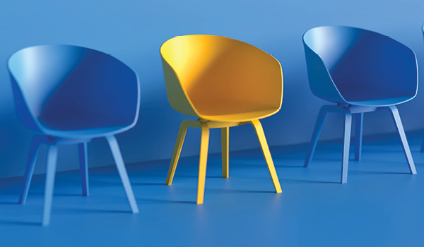 A yellow chair in between two blue chairs