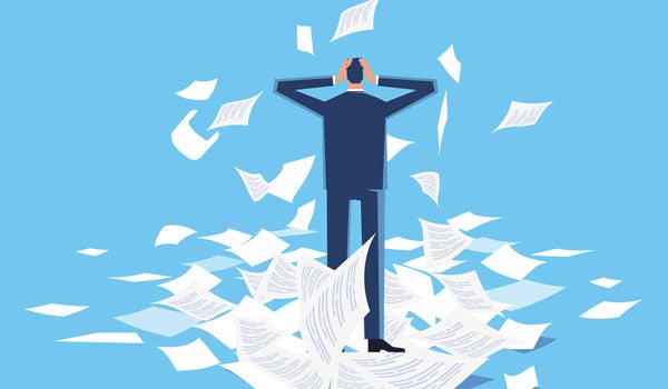 Frustrated person surrounded by falling papers